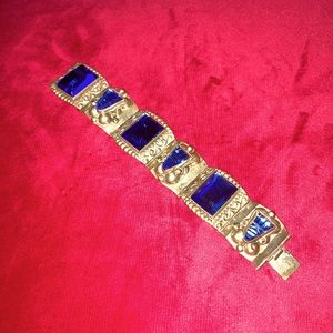 ornate silver and blue gemmed bracelet